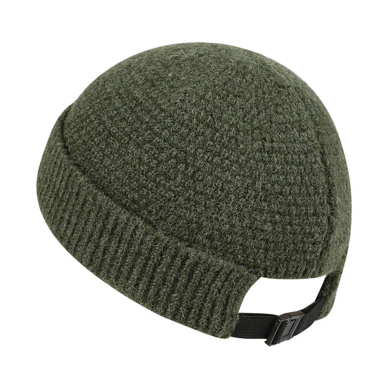 Green knitted wool winter cap with adjustable black strap at back