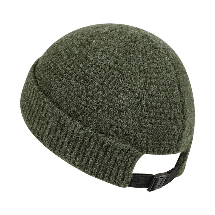 Green knitted wool winter cap with adjustable black strap at back