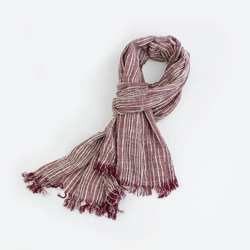 Soft maroon and white striped scarf with fringed edges on a white background
