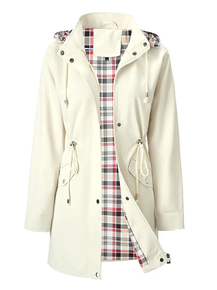 Cream beige hooded raincoat with adjustable drawstrings and red plaid lining inside
