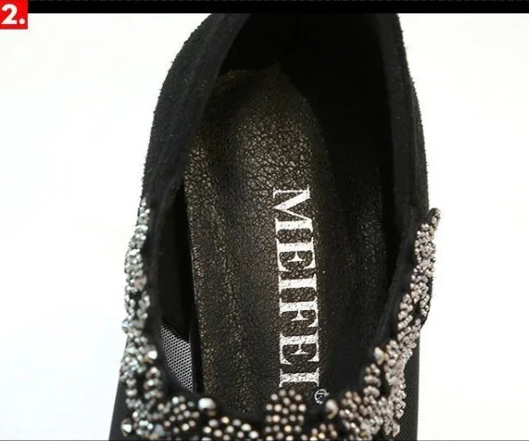 Close-up of black shoe interior with MEIHEEL brand and decorative silver bead embellishments