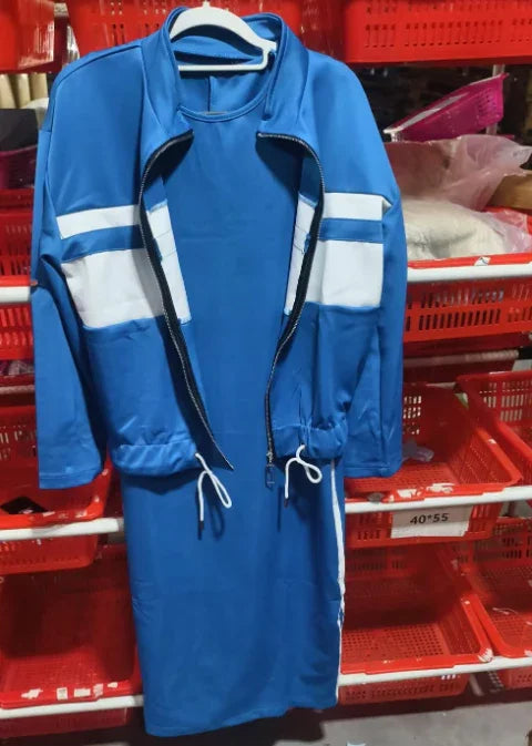Blue two-piece outfit with white stripes hanging on a white hanger against red plastic baskets