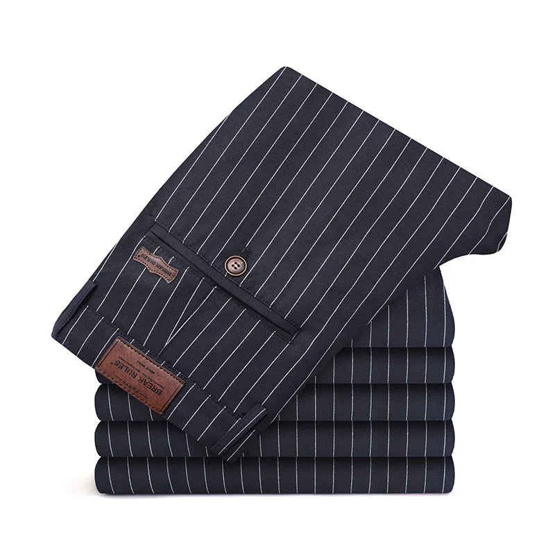Stack of navy blue pinstripe trousers with buttoned back pocket and leather label detail