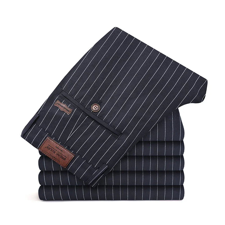 Stack of navy blue pinstripe trousers with buttoned back pocket and leather label detail