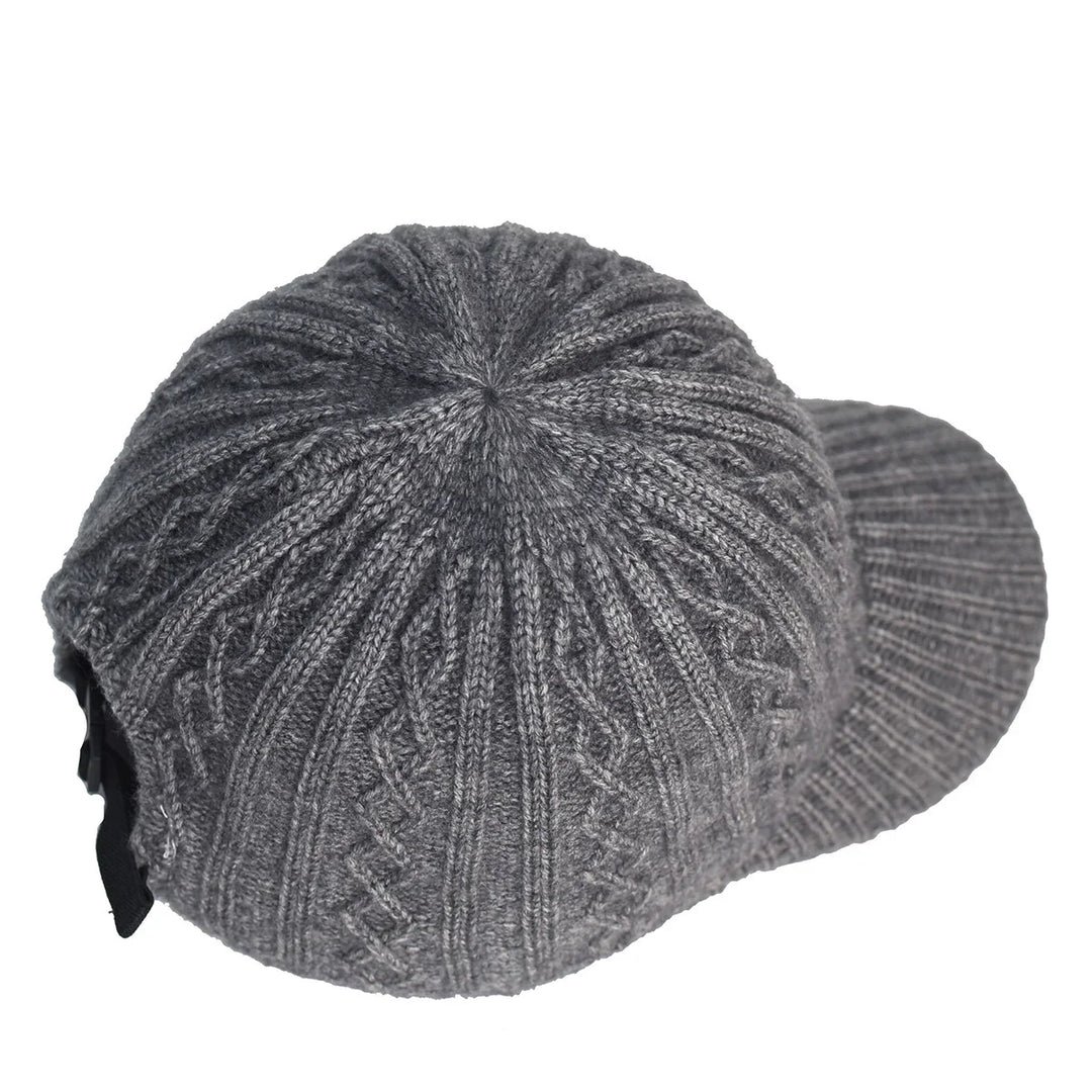 Gray knitted winter cap with visor and textured pattern on white background