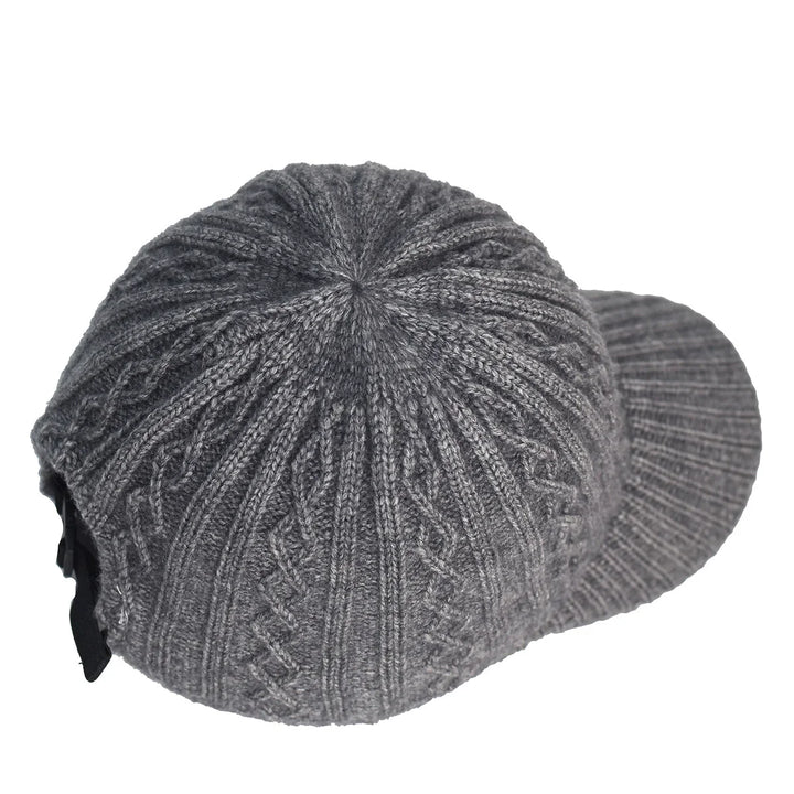 Gray knitted winter cap with visor and textured pattern on white background