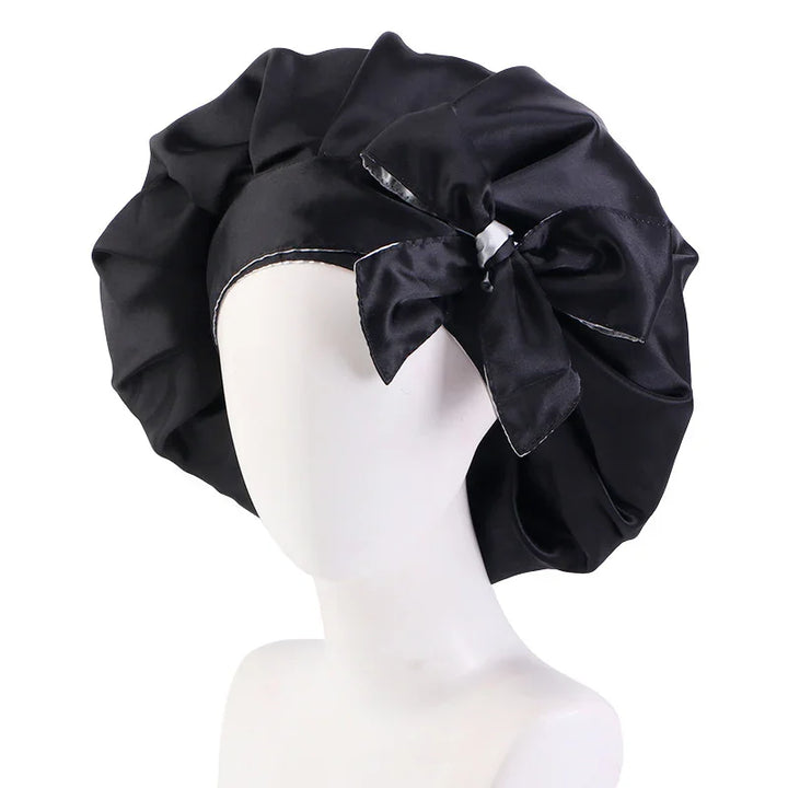 Black satin bonnet with large bow on a white mannequin head