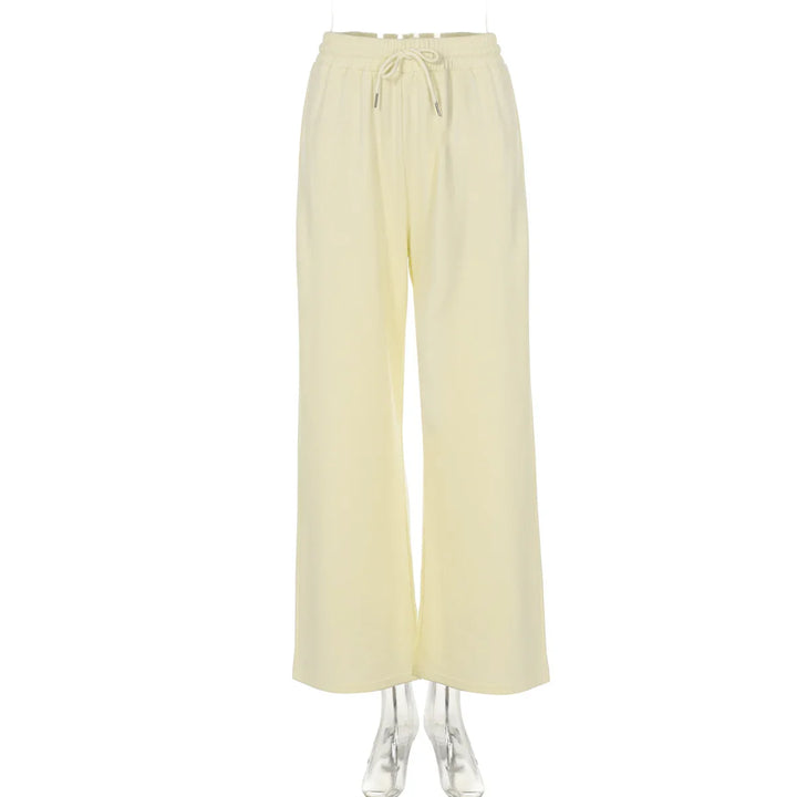 Cream-colored wide-leg pants with elastic waistband and drawstring on mannequin