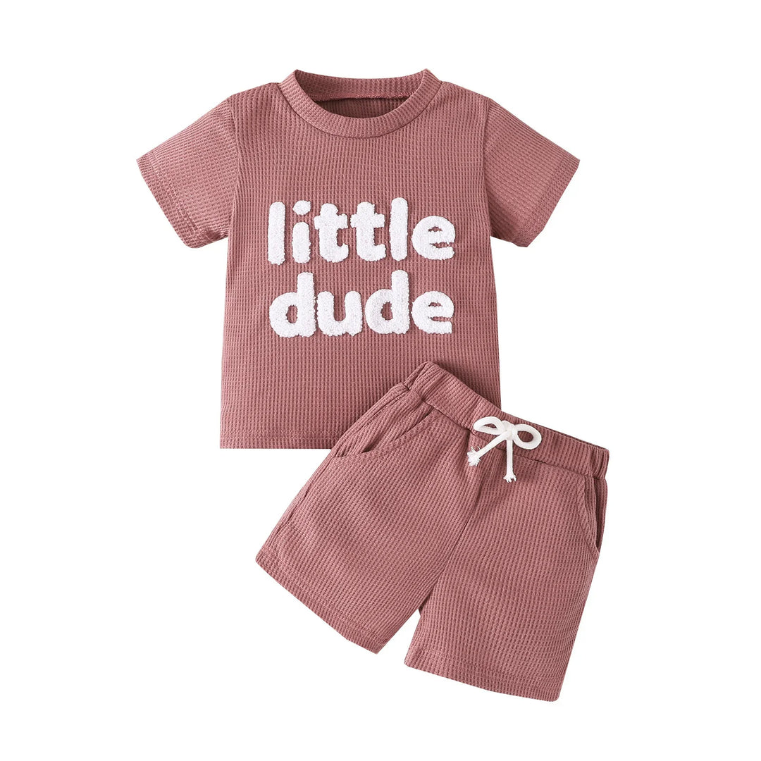Mauve toddler short sleeve shirt with 'little dude' text and matching shorts with drawstring