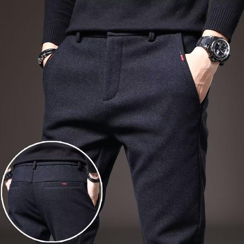 Men's dark formal trousers with front and back pockets, worn with a black sweater and watch