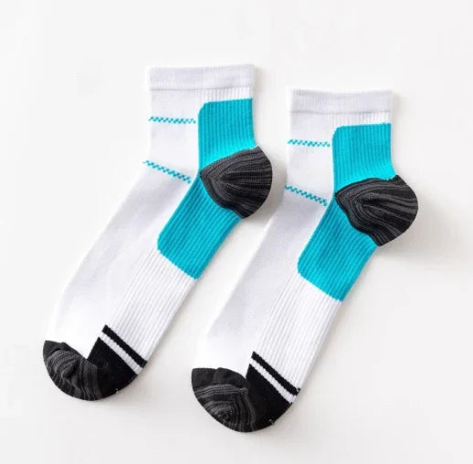Pair of white athletic socks with turquoise arch support and black heel and toe accents