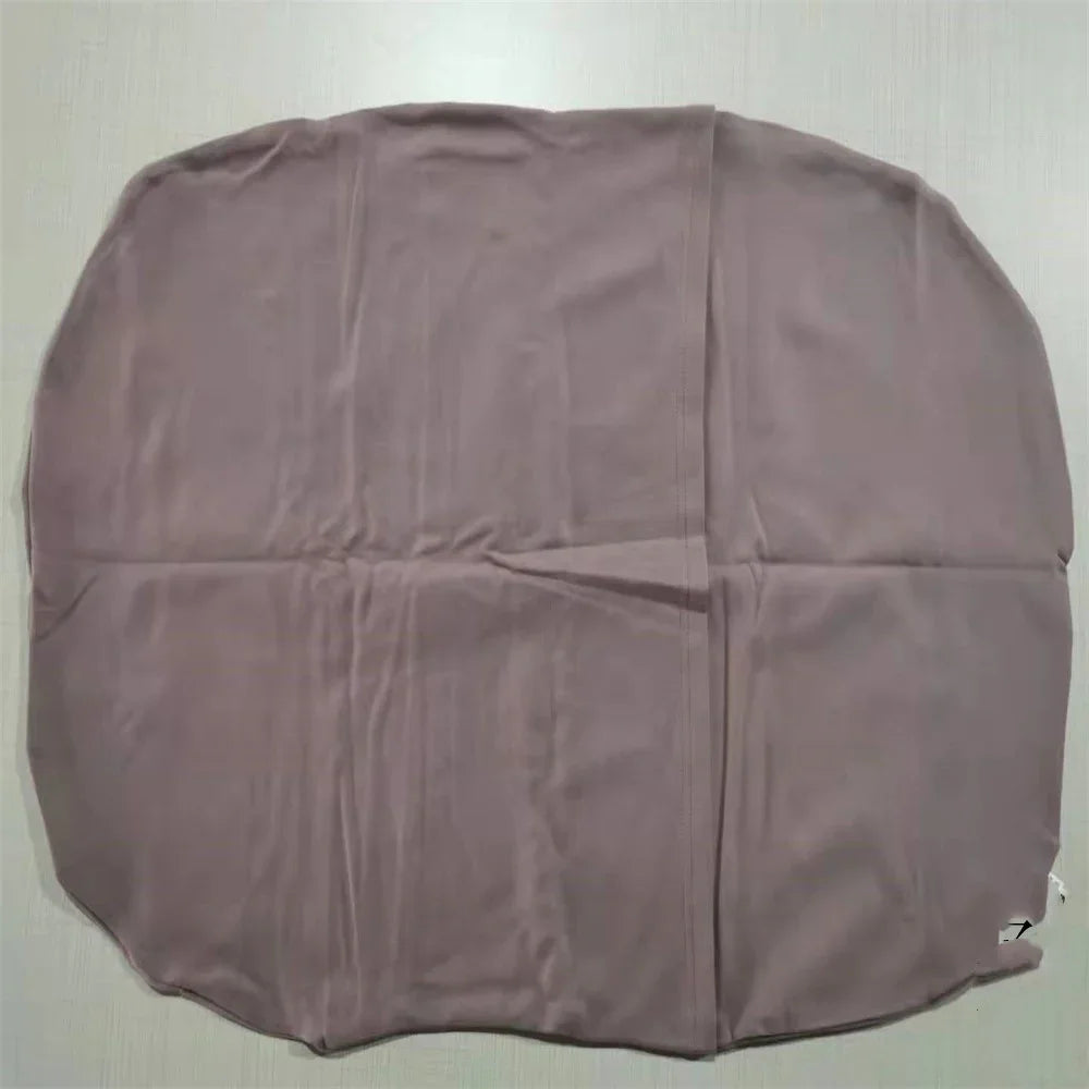 Large soft brown fabric cover or cloth laid flat on a light surface, slightly wrinkled