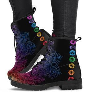 Black lace-up boots with colorful chakra and mandala embroidery worn with black pants