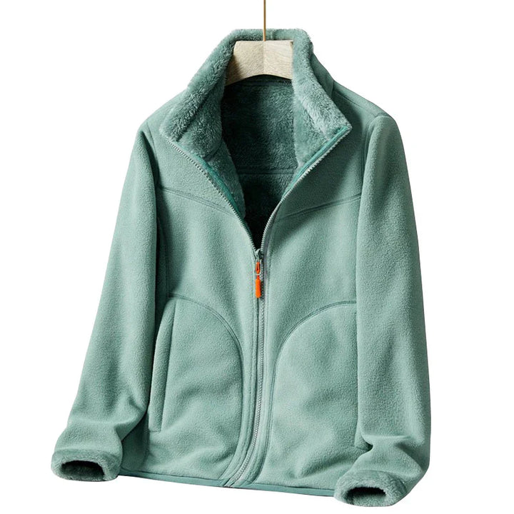 Light green fleece jacket with full zipper and plush inner lining on wooden hanger