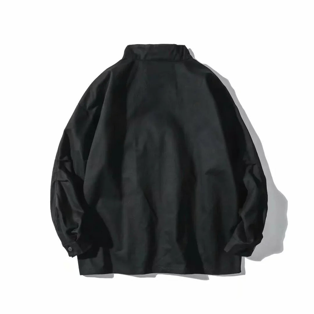 Black long sleeve jacket laid flat on white background with buttoned cuffs and high collar