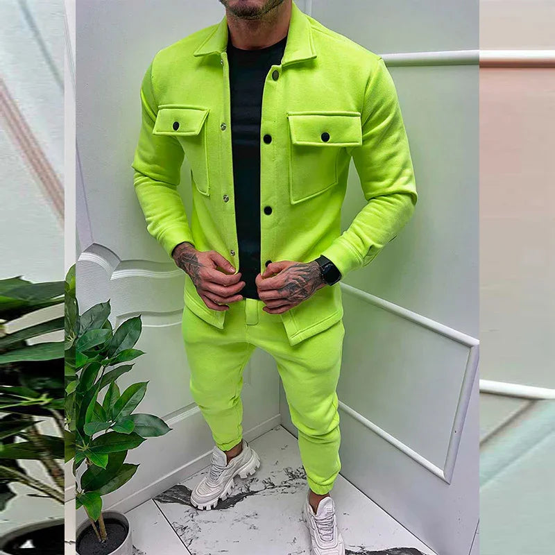 Man wearing neon yellow casual jacket and pants with white chunky sneakers in modern indoor setting