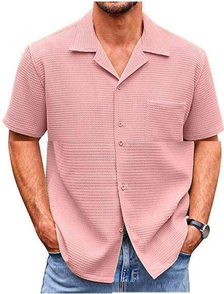 Man wearing pink textured short-sleeve button-up shirt with a single pocket and light blue jeans