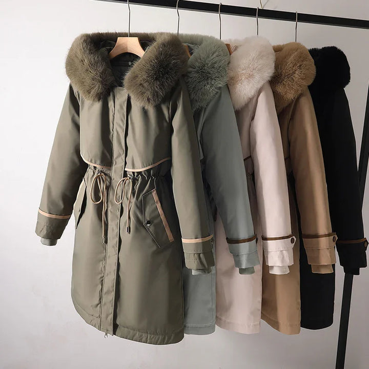 Winter parkas with fur collars in green, blue, beige, brown, and black hanging on a rack