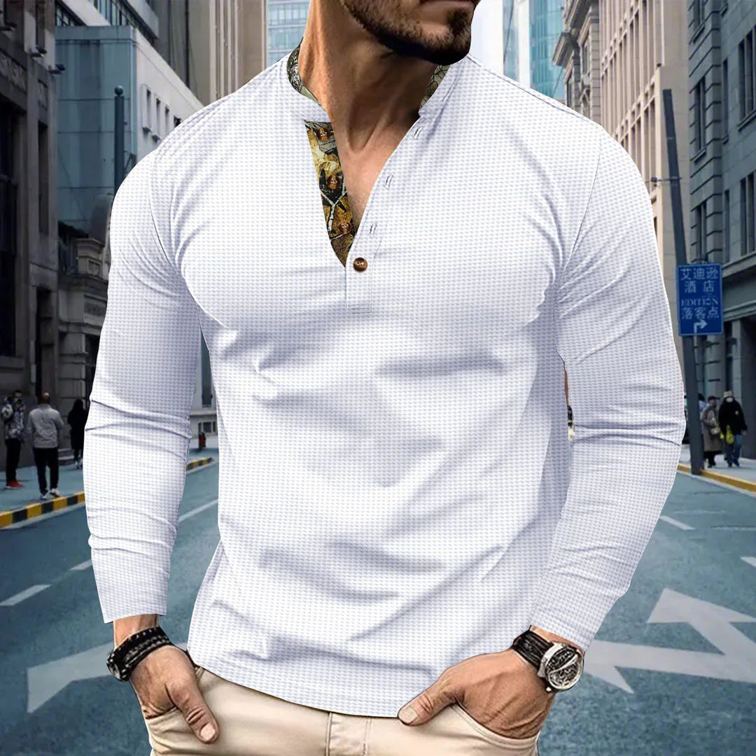 Man wearing white long-sleeve henley shirt with floral print placket in urban street setting