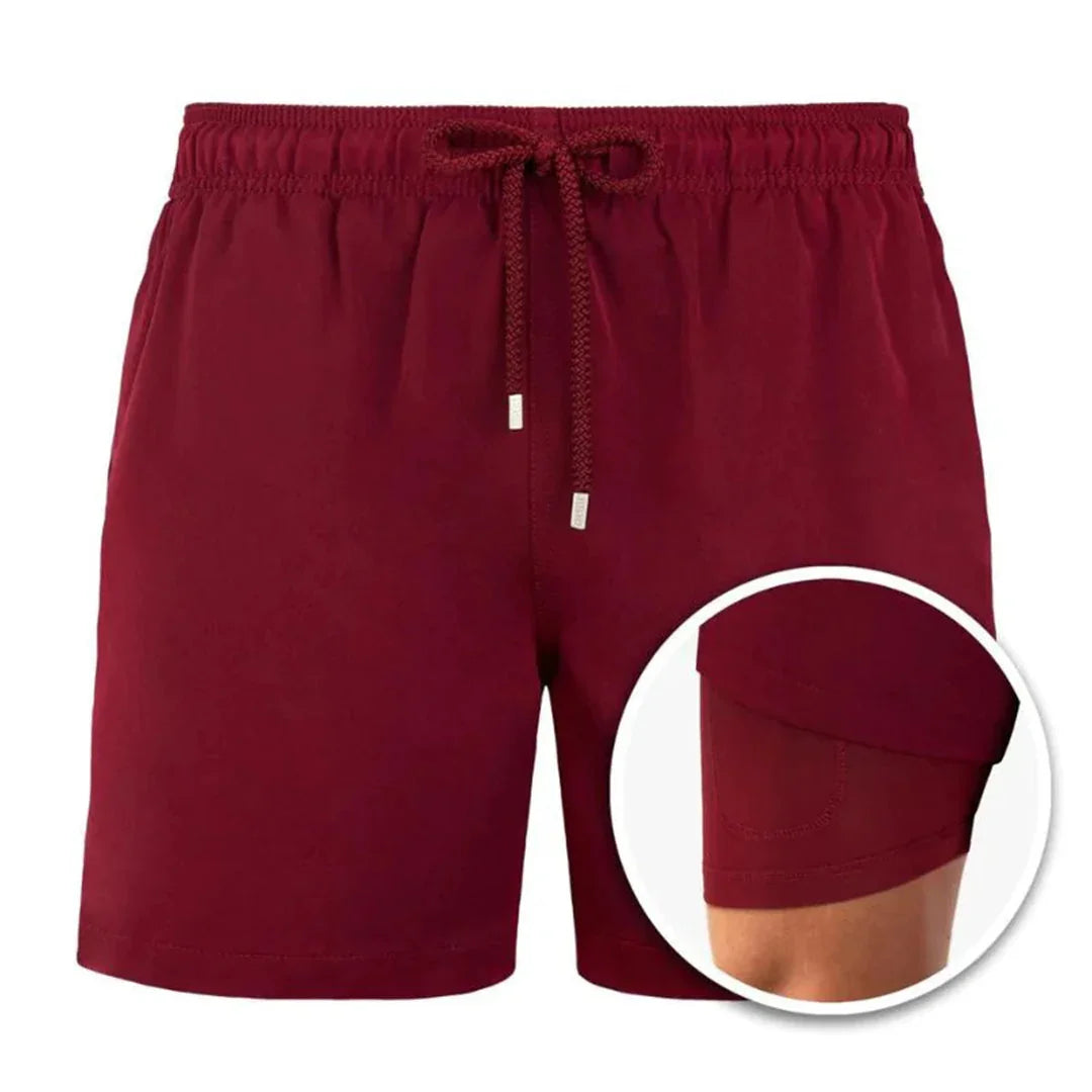 Maroon men's athletic shorts with elastic waistband and inner compression liner close-up