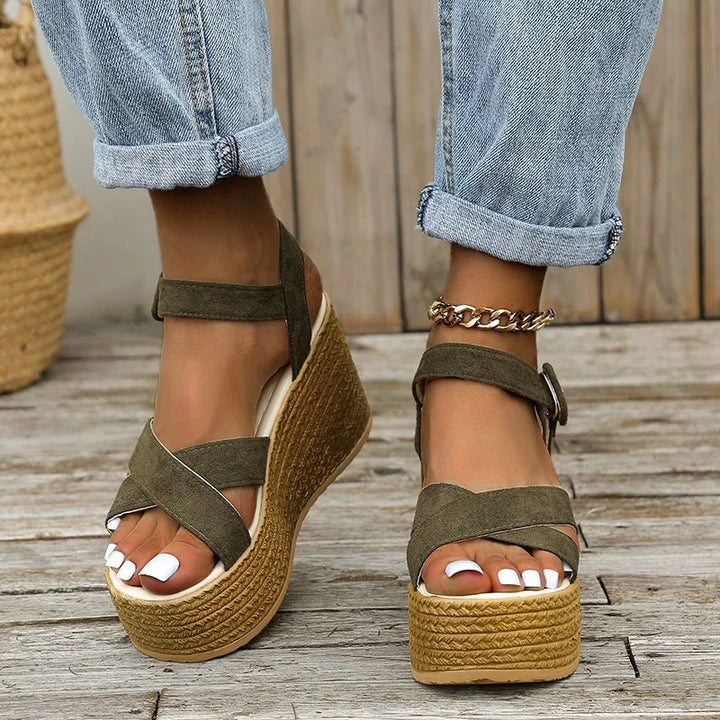 women's khaki suede platform wedge sandals with ankle strap and gold chain anklet on wooden deck