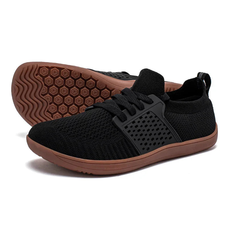 Black breathable mesh athletic shoes with brown flexible rubber soles and black lace cage