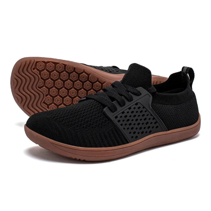 Black breathable mesh athletic shoes with brown flexible rubber soles and black lace cage