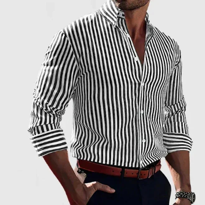 Man wearing black and white vertical striped slim fit dress shirt with rolled sleeves and brown belt