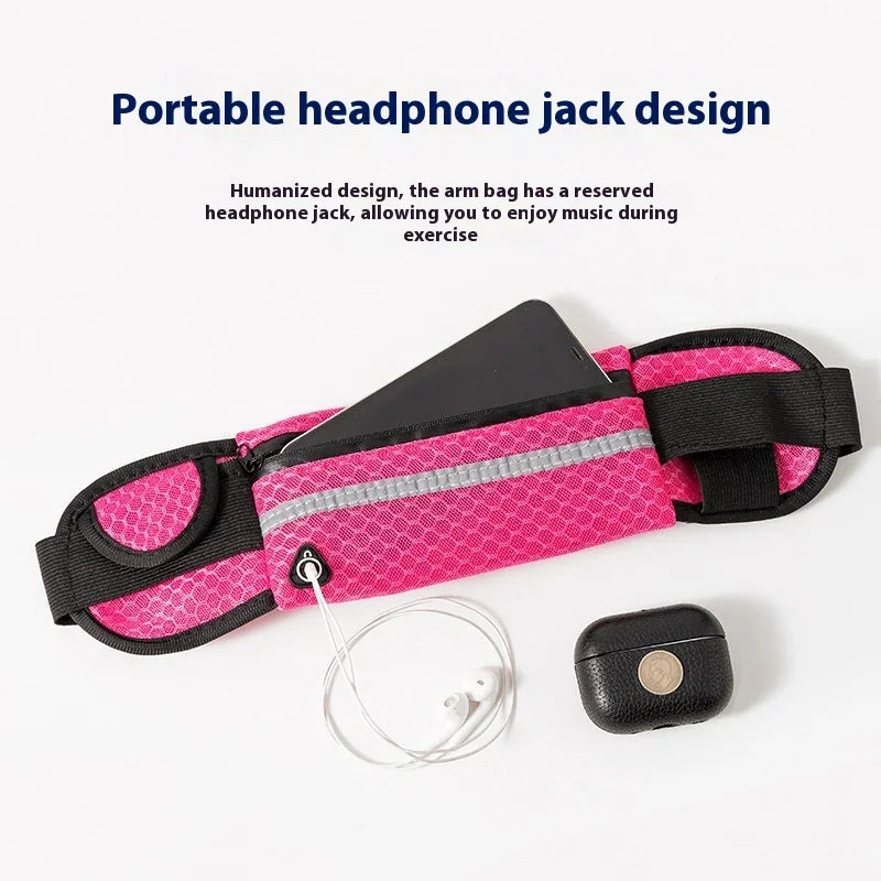 Pink exercise arm bag with headphone jack holding smartphone, white earphones, and black wireless earbuds case