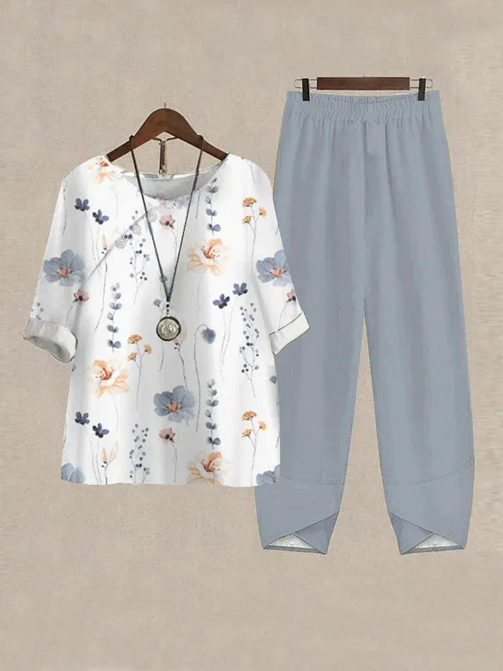 Women's casual two-piece outfit with floral print white top and light blue elastic waist pants