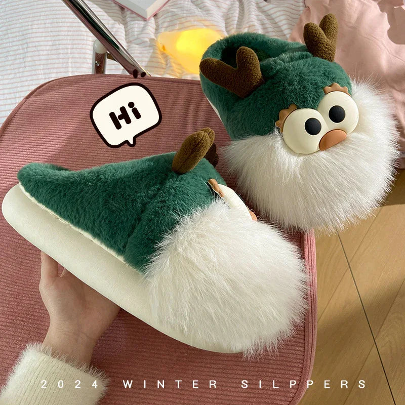 Cozy green winter slippers with cute reindeer design, fluffy white beard, and antlers on pink chair