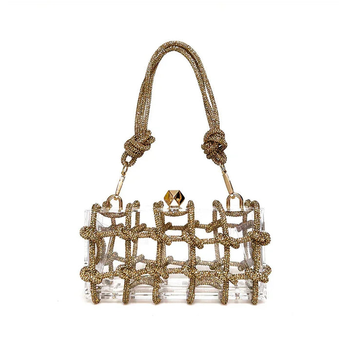 Transparent handbag with gold beaded grid overlay and knotted handles on white background