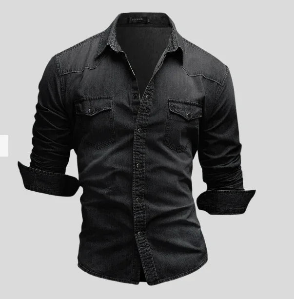 Men's black denim shirt with buttoned front and two chest pockets, long sleeves rolled up
