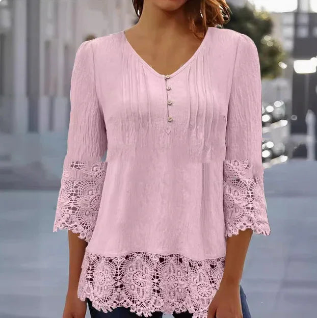 Woman wearing light pink lace trim blouse with 3/4 sleeves and button front detail
