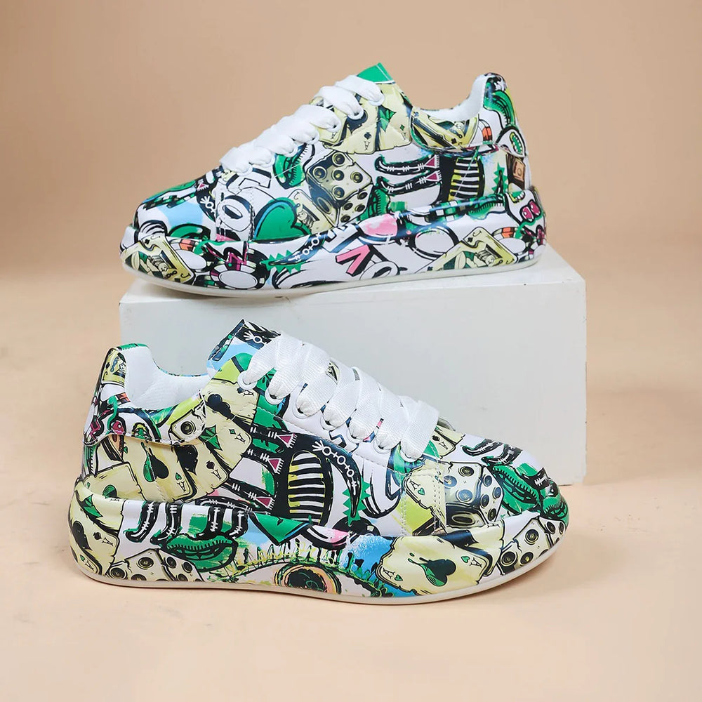 Colorful casual sneakers with abstract green, black, and beige graphic pattern on white surface