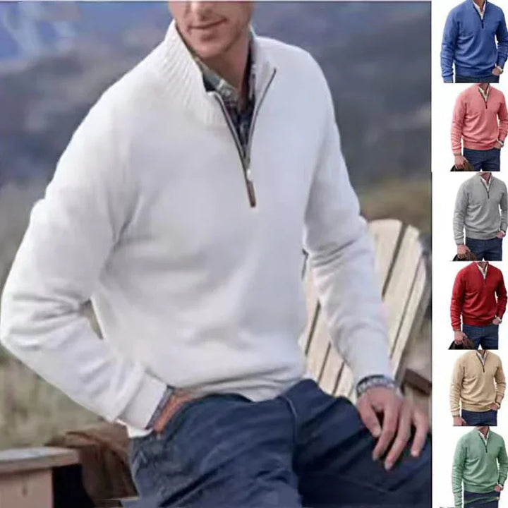 Man wearing white quarter-zip pullover sweater with plaid shirt and blue pants outdoors, plus five color options
