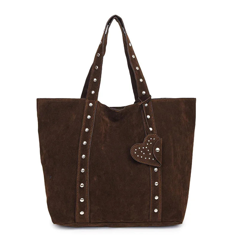Brown suede tote bag with studded straps and heart-shaped studded charm