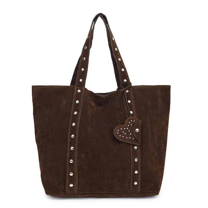Brown suede tote bag with studded handles and heart-shaped studded charm