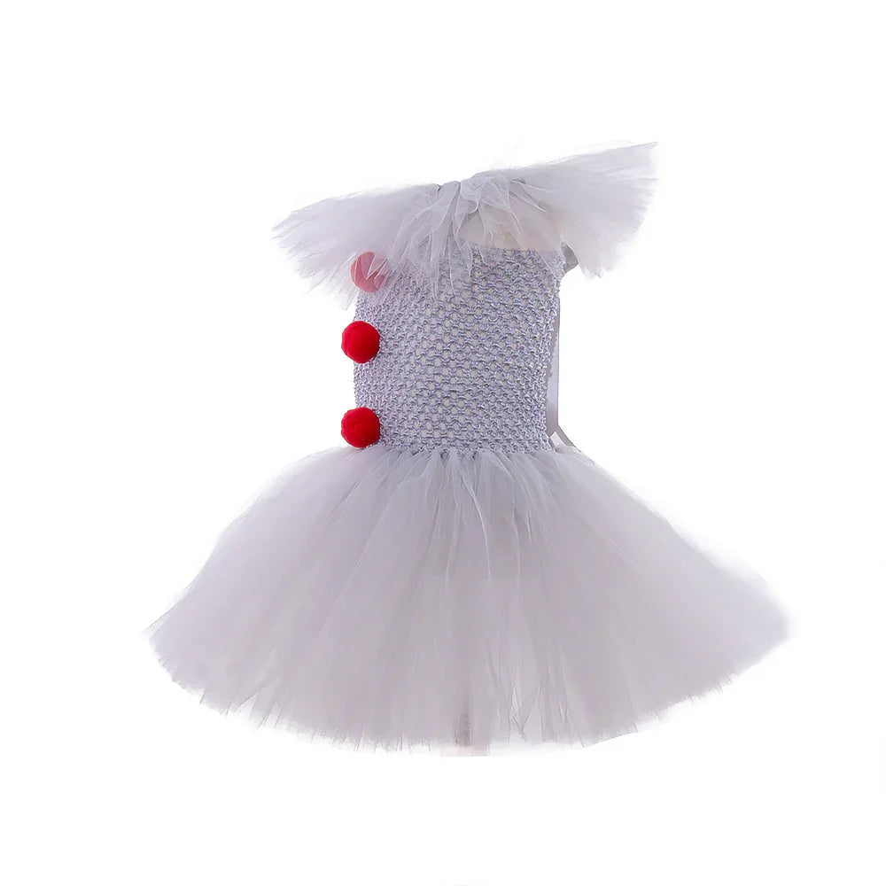White tulle baby girl dress with puffy sleeves and red pom pom decorations