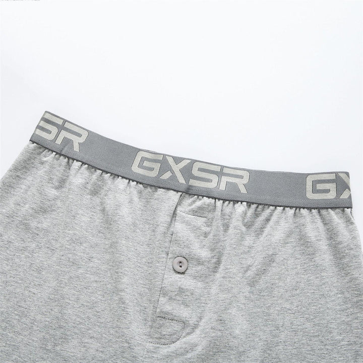 Close-up of gray men's boxer shorts with GXSR branded waistband and front button fly
