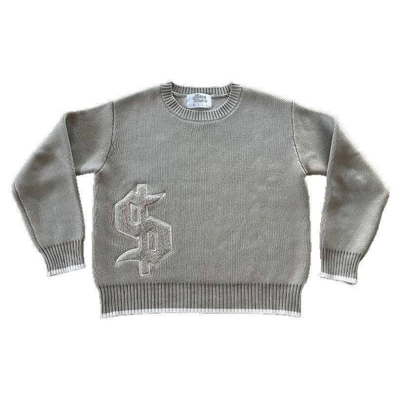 Gray knit crewneck sweater with ribbed cuffs and hem, featuring a textured Gothic-style logo on the front