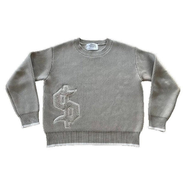 Gray knit crewneck sweater with ribbed cuffs and hem, featuring a textured Gothic-style logo on the front
