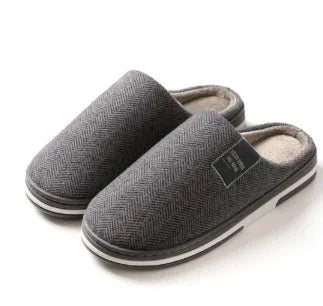 Gray herringbone pattern indoor slippers with soft beige lining and black and white sole