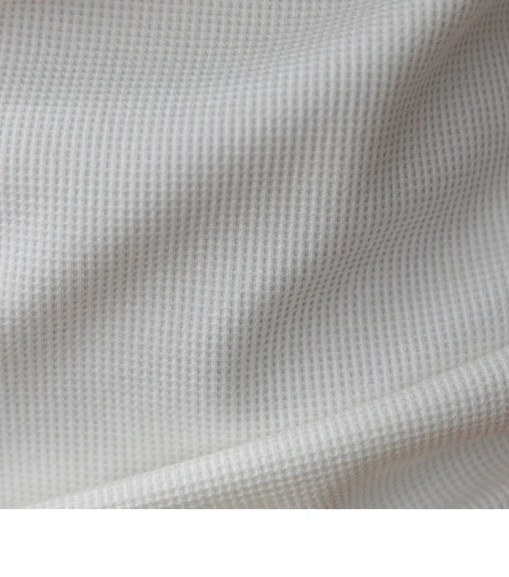close-up of soft white waffle textured fabric with subtle folds