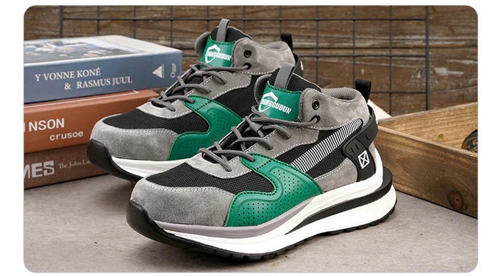 Gray and green casual sneakers with black mesh, white soles, and branded tongue on a concrete surface