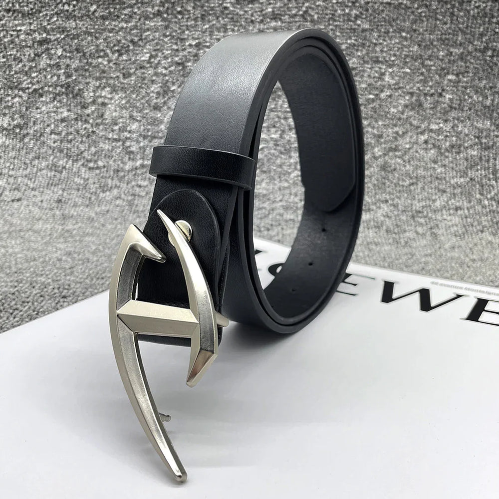 Black leather belt with unique silver H-shaped buckle on white surface against gray textured background