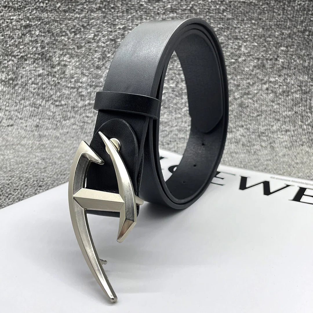 Black leather belt with unique silver H-shaped buckle on white surface against gray textured background