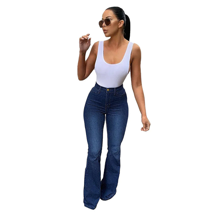 Woman wearing white sleeveless top and high-waisted dark blue flare jeans with sunglasses