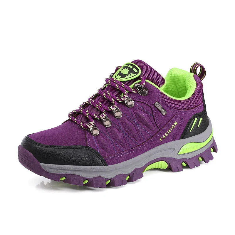 Purple and neon green fashion hiking shoe with durable sole and metal eyelets on white background