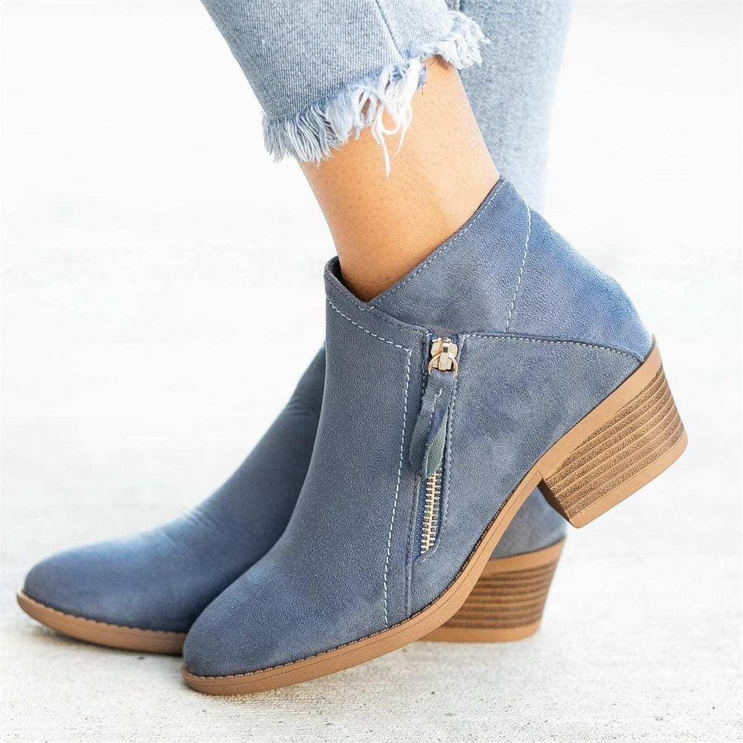 Blue suede ankle boots with side zipper and stacked wooden heel worn with frayed hem jeans